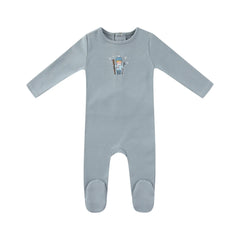 A front view of the Mini Label blue baby footie with a Vintage Skier graphic.