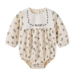 A front view of the Nou Nelle cream corduroy baby romper.