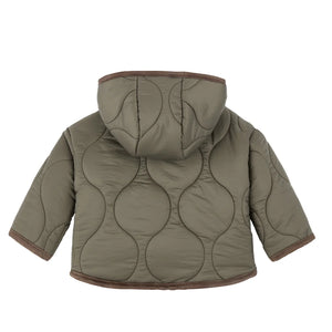 Green quilted jacket with brown trim on a white background