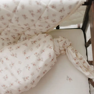 A high-resolution close-up of the delicate rose blossom print and soft cotton muslin texture.