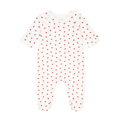 A front view of the soft white Petit Bateau velour footie with red heart prints and side snaps.