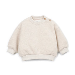 A front view of the Play Up fleece sweater in beige.