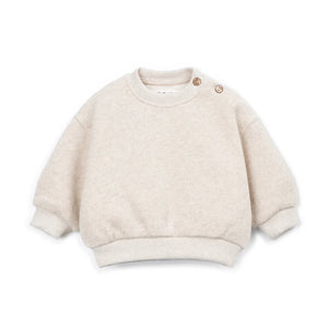 A front view of the Play Up fleece sweater in beige.