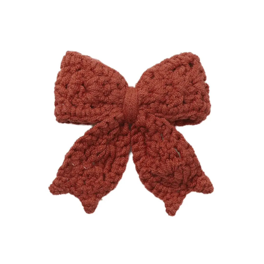 A flat-lay view of the Quincy Mae crochet hair bow in redwood.