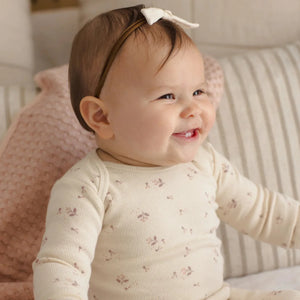An infant playing comfortably while wearing the Quincy Mae Fall Ditsy tee and leggings.