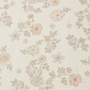 A high-resolution close-up of the breathable organic cotton texture and vine floral print.