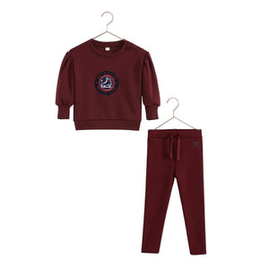 A vibrant cranberry red RetroKid Arden two-piece baby outfit made from smooth, stretchy scuba fabric.