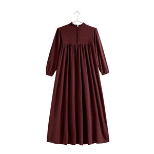 The back view of the burgundy knit RetroKid Isla maxi dress, showcasing its sweeping silhouette.