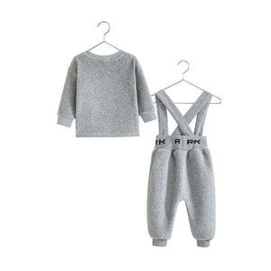 The back view of the gray and green RetroKid baby boy overalls set, showing the strap details.