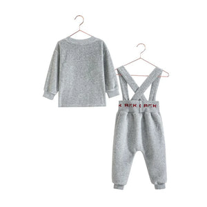 The back view of the RetroKid baby girl overalls set in gray and red.