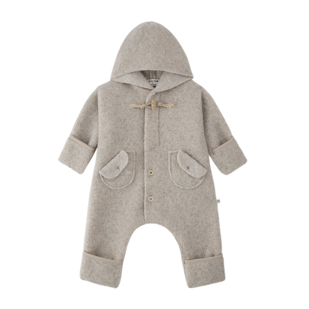 A front view of the 1+ in the Family CANNES infant polar suit in beige color.