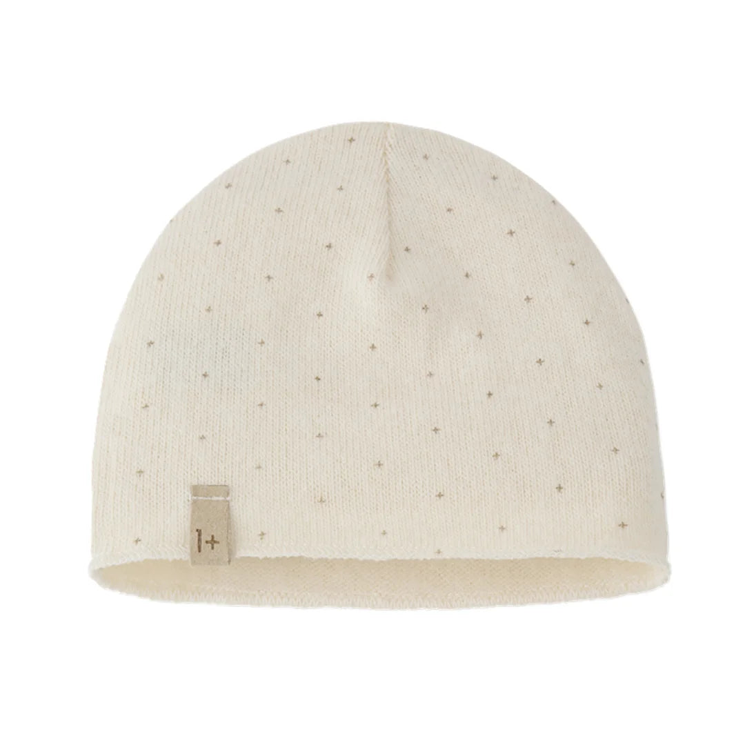 Beige knit baby hat with a small label on a white background
