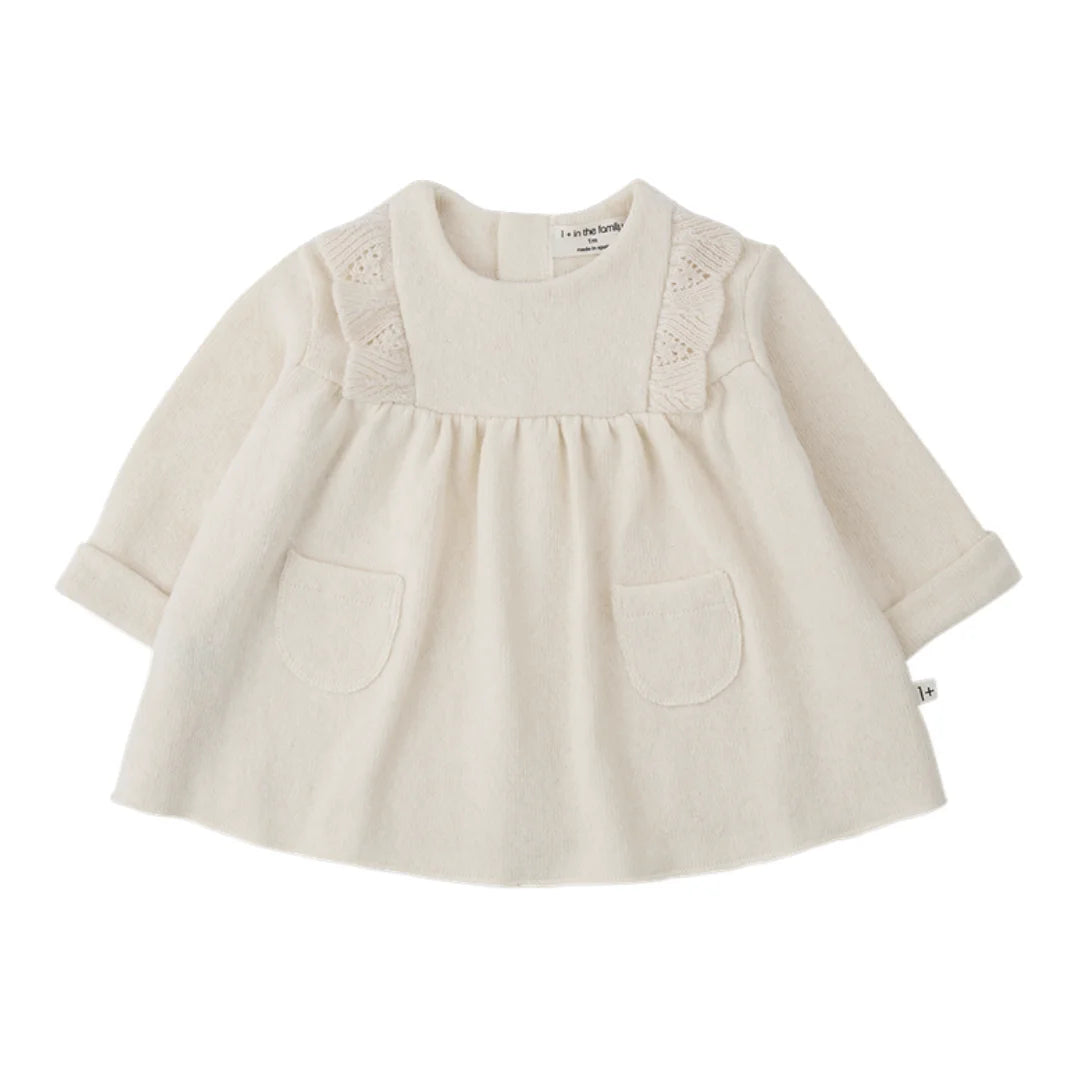 A soft, flowy 1+ in the Family TALENCE dress for babies and toddlers in a natural ecru color.