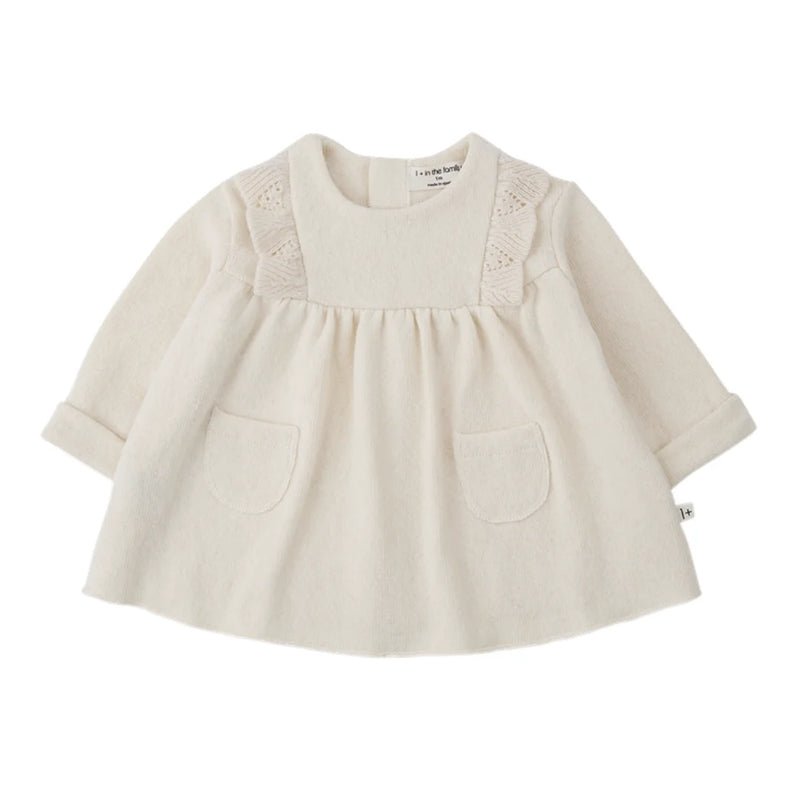A soft, flowy 1+ in the Family TALENCE dress for babies and toddlers in a natural ecru color.