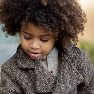 A breathtaking 1+ in the Family Viareggio Pea Coat featuring an immaculate dark taupe palette and classic tailored button detailing.