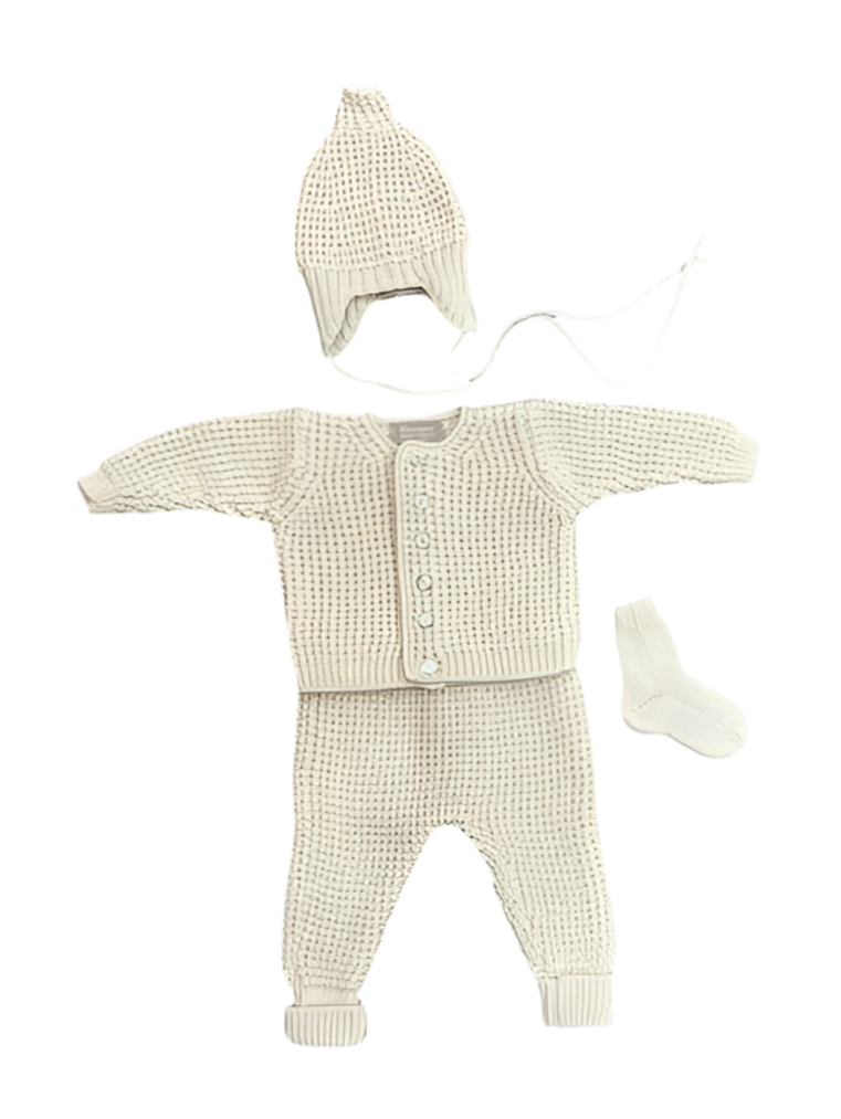 Baby outfit set with cardigan, pants, hat, and socks on a white background