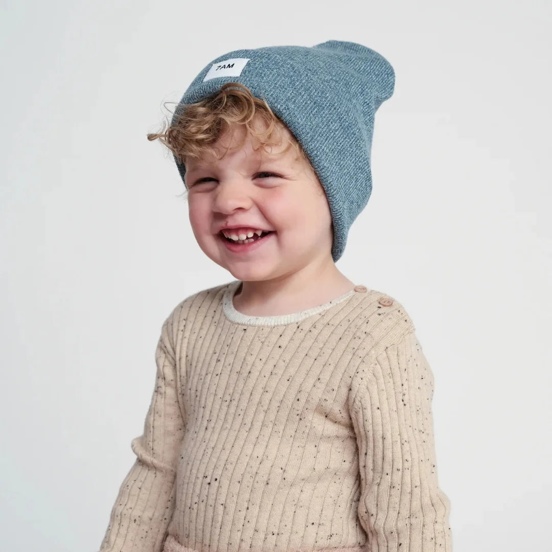 A child wearing the 7AM Enfant beanie comfortably