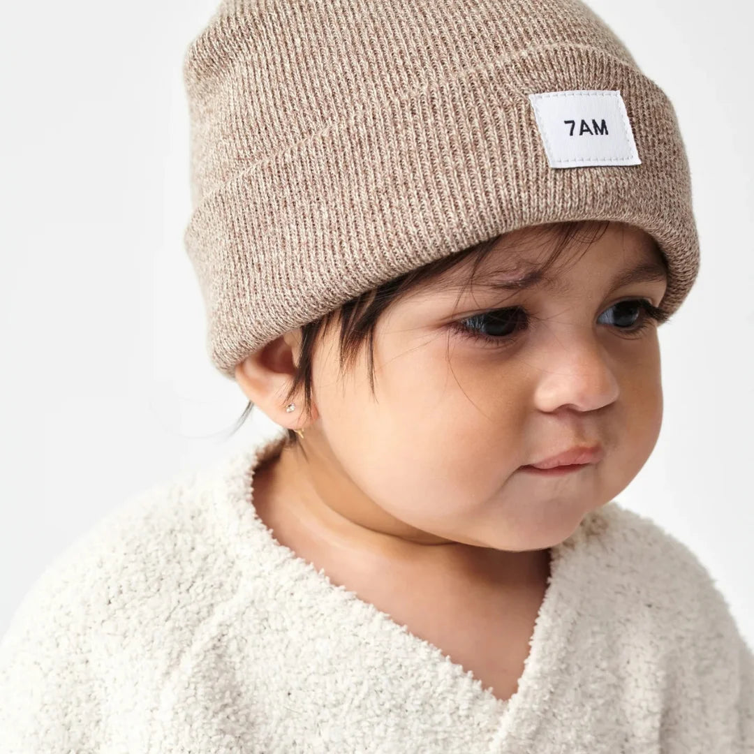 A child wearing the 7AM Enfant beanie comfortably