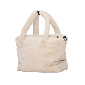 A high-resolution close-up of the plush faux fur trim and interior pockets.