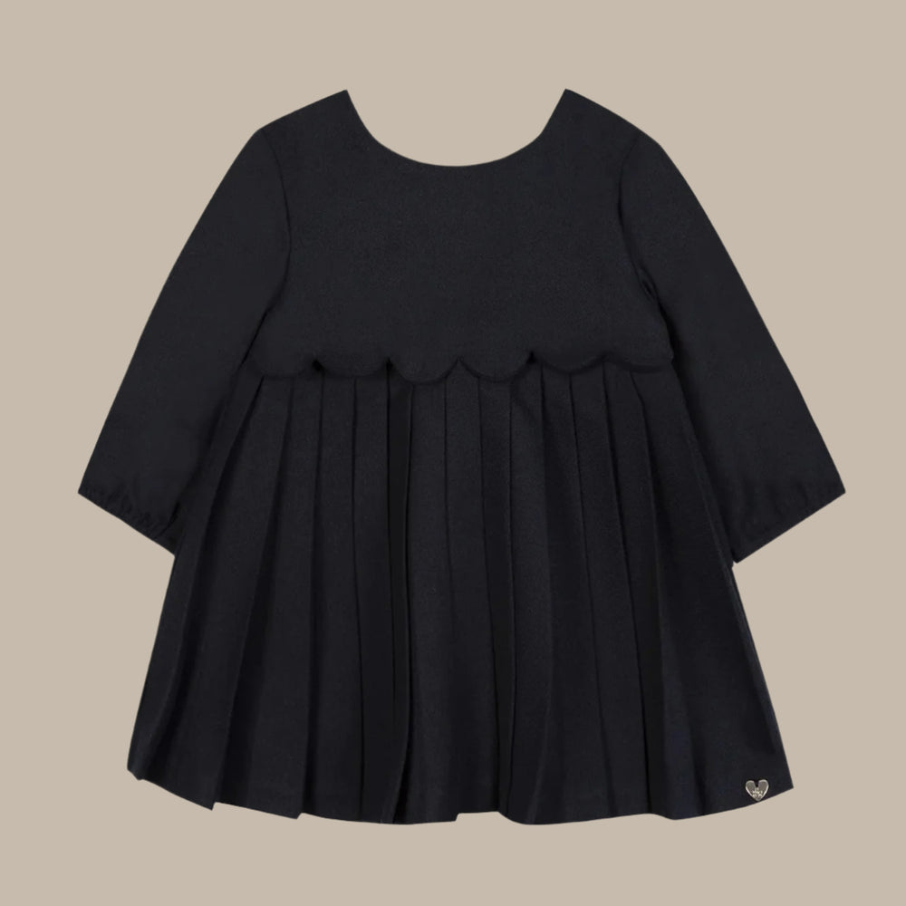 Black dress with ruffled layers on a white background
