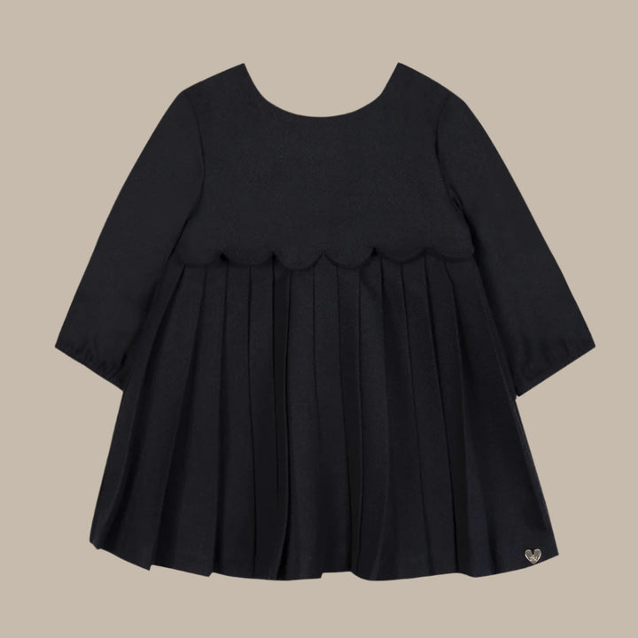 Black dress with ruffled layers on a white background