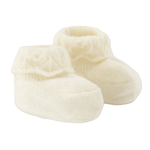 Pair of cream-colored baby booties on a white background