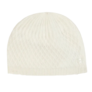 White knit beanie on a beige background