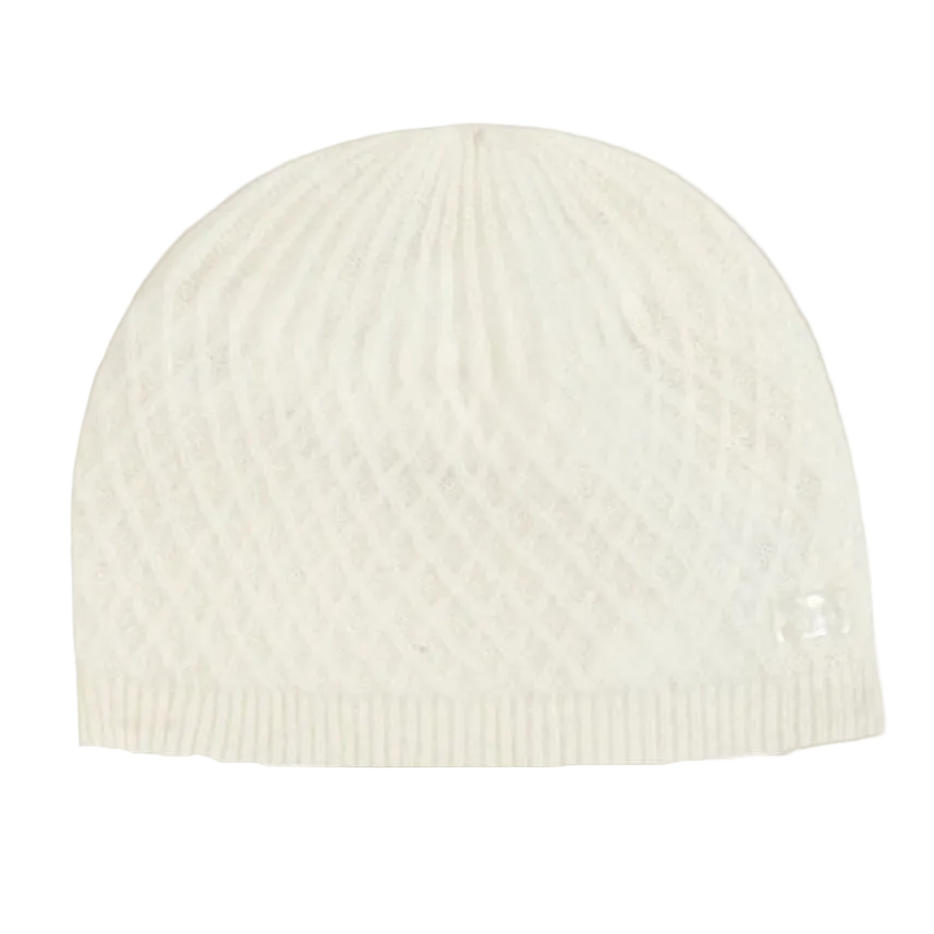 White knit beanie on a beige background