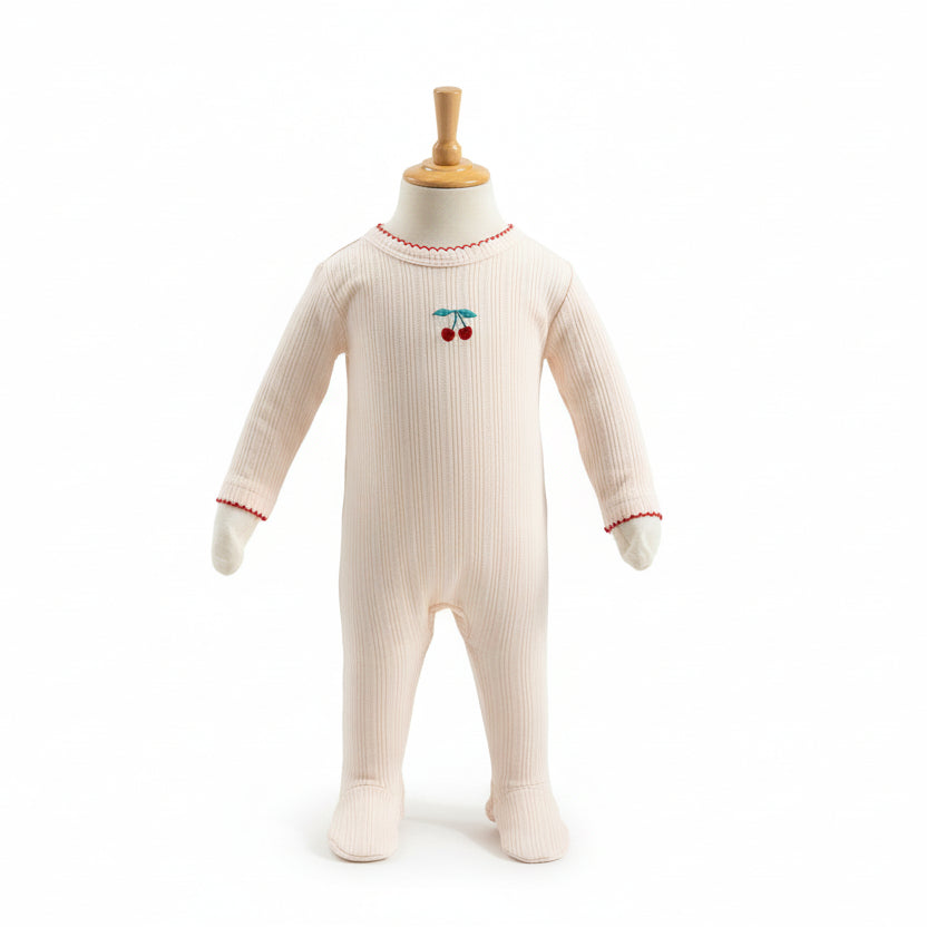 Baby onesie with cherry design on a mannequin against a white background