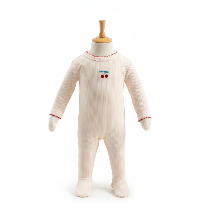 Baby onesie with cherry design on a mannequin against a white background