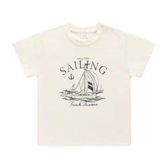 Beige t-shirt with sailing graphic and text on a white background