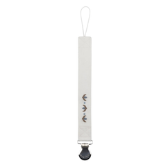 White pacifier clip with decorative elements on a white background