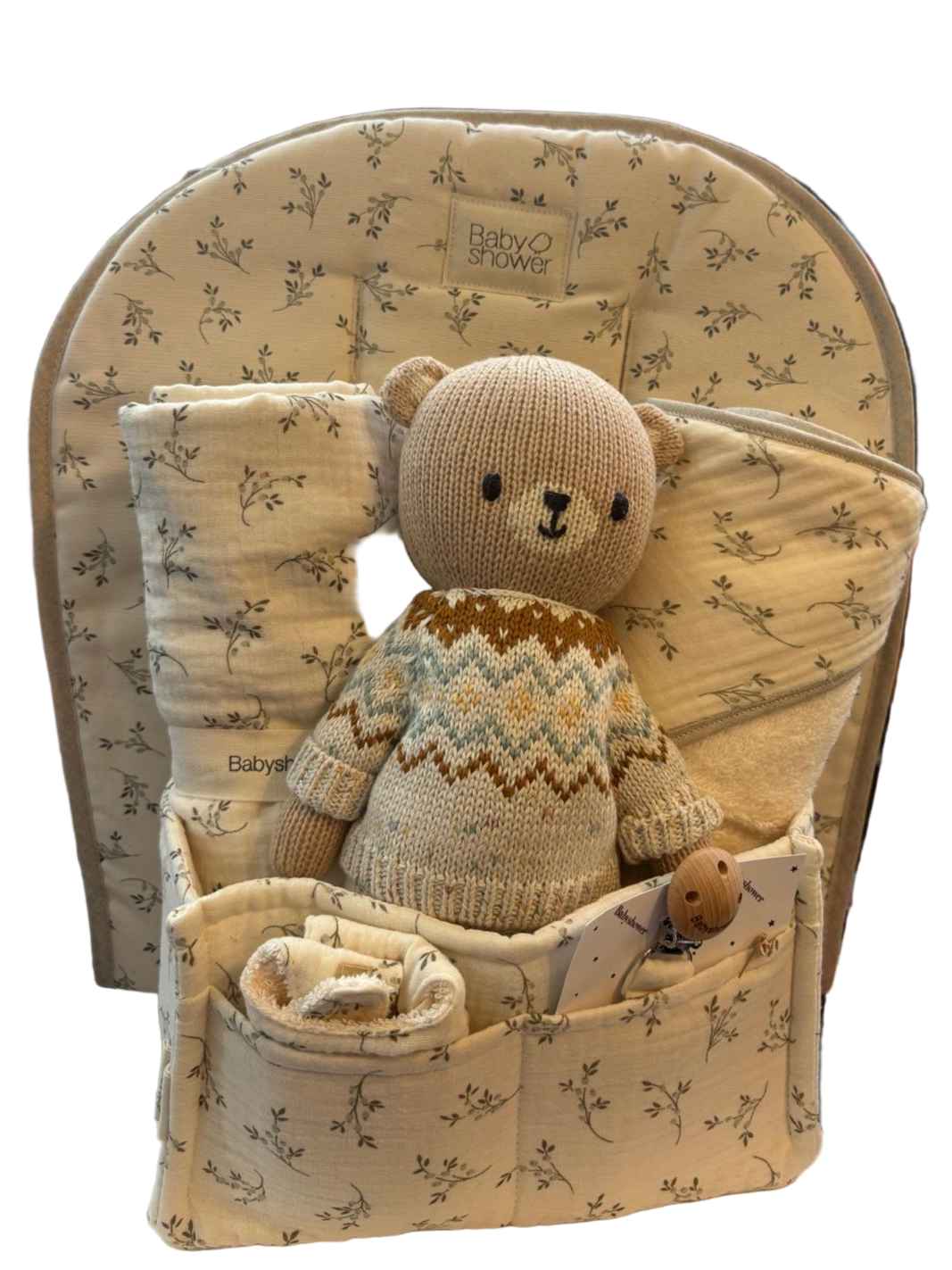 Baby seat with teddy bear and blanket in a store setting