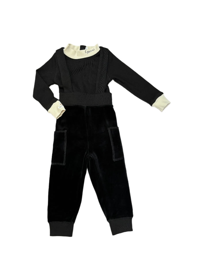 Black outfit with white accents on a wooden floor