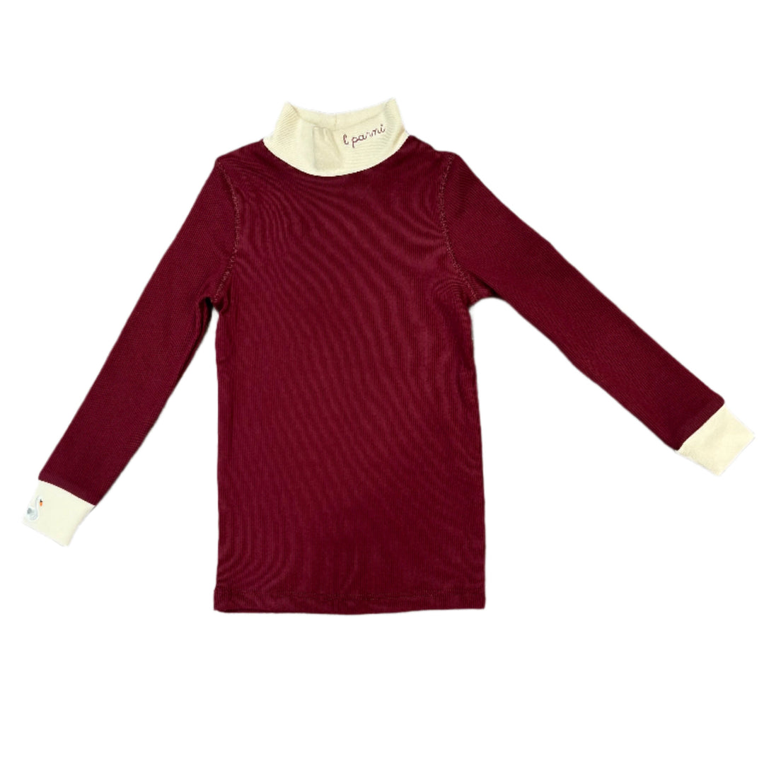 Maroon long-sleeve shirt with white cuffs and hem on a wooden floor.