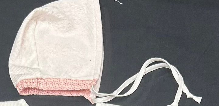 Knit bonnet with printed trim rose
