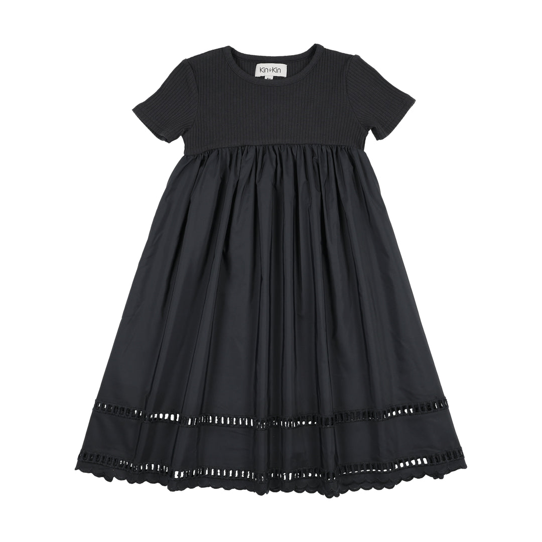 Black dress with lace trim on a white background