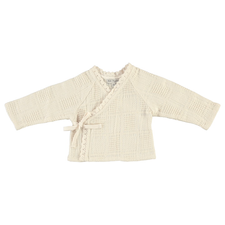 Beige baby cardigan on a white background