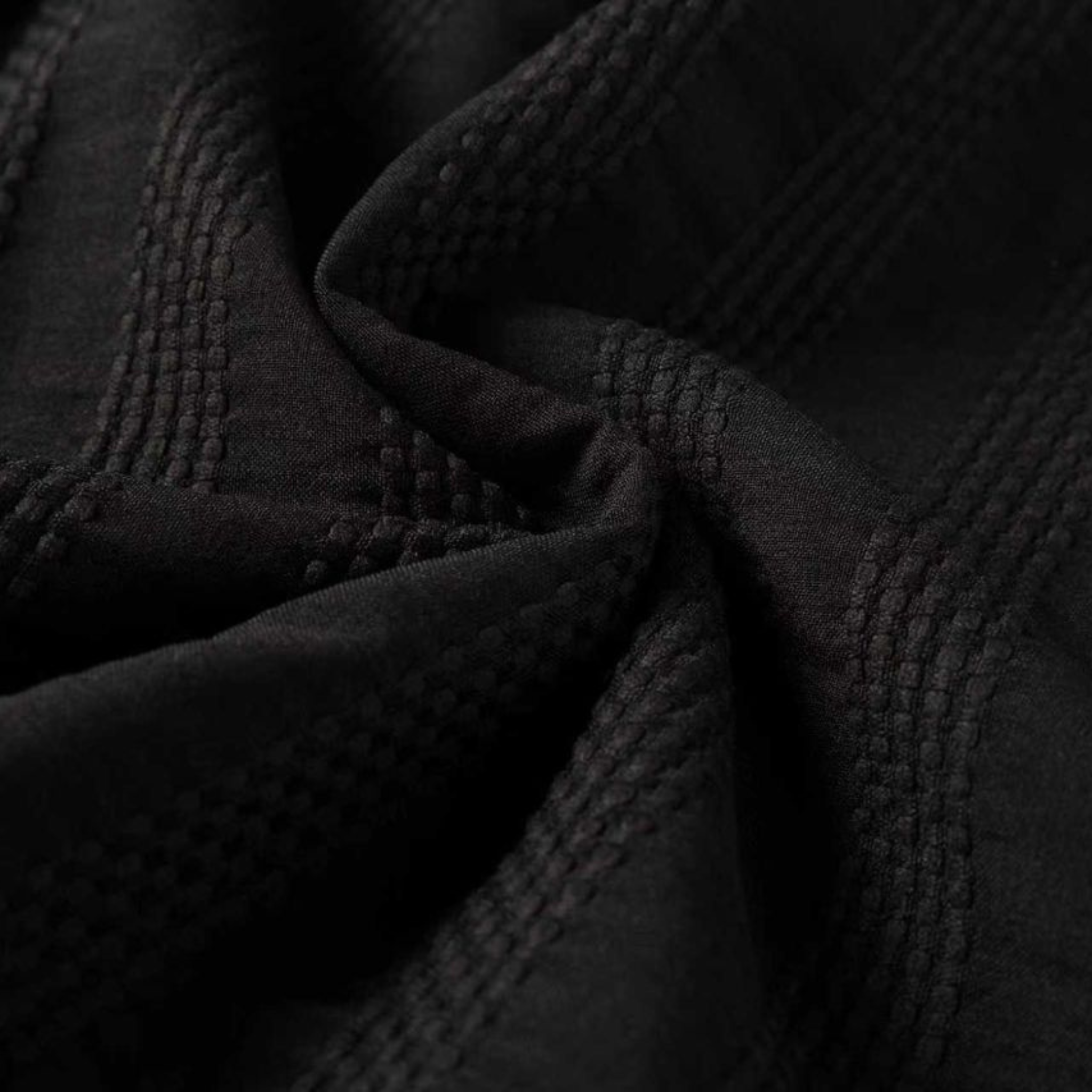 Close-up of textured black fabric with intricate patterns