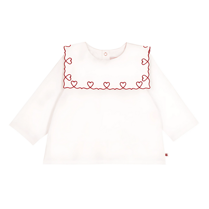 White long-sleeve top with red heart embroidery on a white background