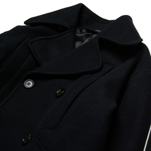 Close-up of a dark coat with buttons on a white background