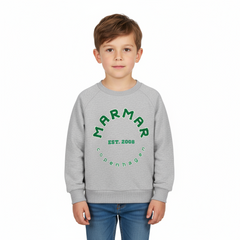 Child wearing a gray sweatshirt with green text on a white background