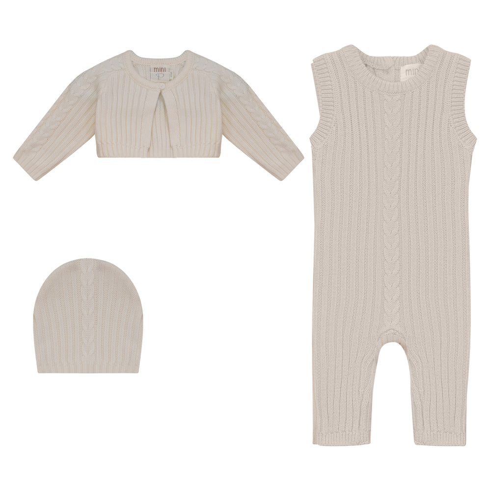 Baby outfit set with cardigan, romper, and hat on a white background