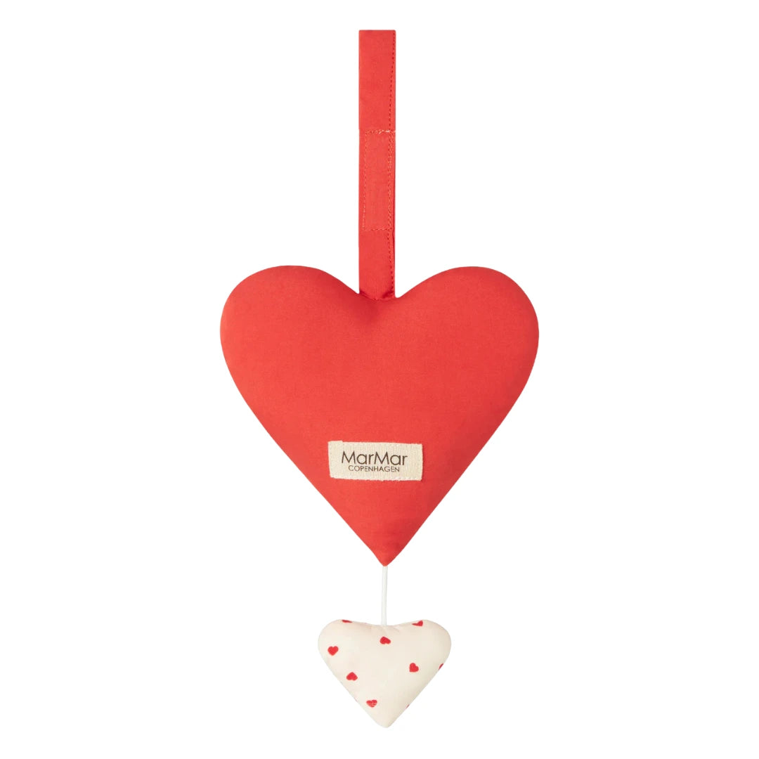 Red heart-shaped hanging ornament with a smaller white heart below on a white background