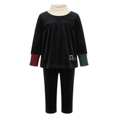 Black velvet outfit with a white turtleneck on a white background
