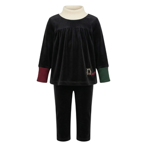 Black velvet outfit with a white turtleneck on a white background