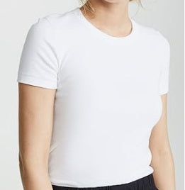 Person wearing a plain white t-shirt on a light gray background