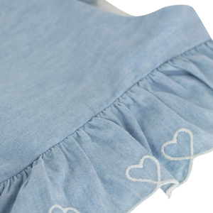 Light blue denim skirt with white heart embroidery on a white background