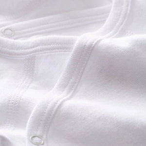 Close-up of white fabric with a button detail