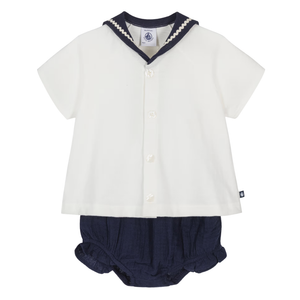 White shirt with navy trim and matching navy bloomers on a white background